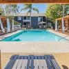 Large sparkling blue pool with lounge chairs and cabanans
